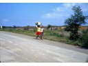 Small children carrying their goods on their head